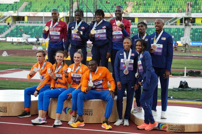 Team Dominican Republic, Team Netherlands, and Team United States pose with their medals following the 4x400 meter relay final on Friday.