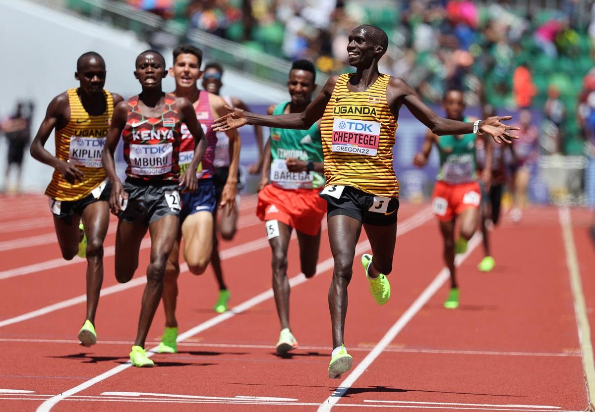 Joshua Cheptegei celebrates as he crosses the line to win the men's 10,000 metres final.