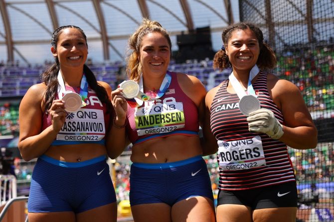 Gold medallist Brooke Andersen of the United States celebrates after winning the women's hammer throw final alongside silver medallist Camryn Rogers of Canada and bronze medallist Janee' Kassanavoid of the US.