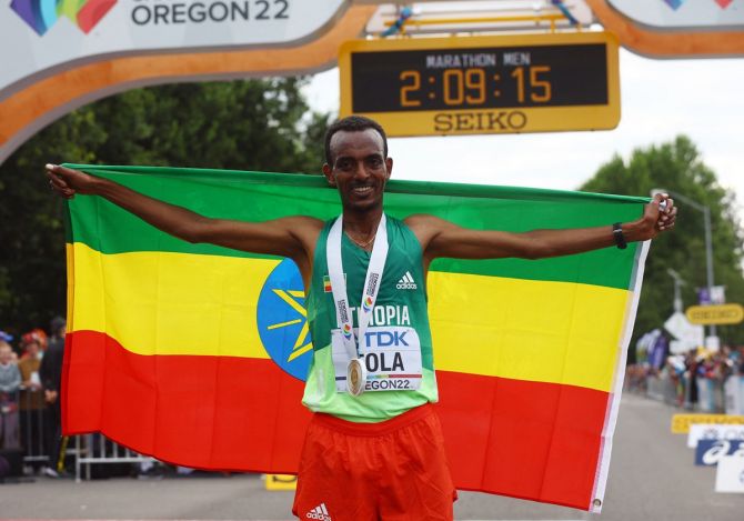 Ethiopia's Tamirat Tola celebrates winning the men's marathon and setting a new World Championship record.