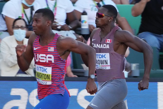 Erriyon Knighton of the United States, left, and Canada's Aaron Brown compete in their men's 200m heat.