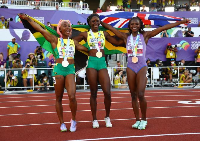 Jamaica's Shericka Jackson celebrates with silver medallist Jamaica's Shelly-Ann Fraser-Pryce and bronze medallist Britain's Dina Asher-Smith after winning gold in the women's 200 metres final and setting a new World Championships record.