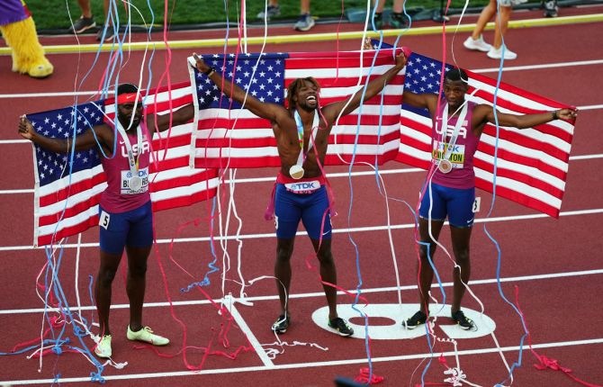 The United States trio of Noah Lyles (gold), Kenny Bednarek (silver) and gold medallist Erriyon Knighton (bronze) celebrate after sweeping the men's 200 metres final at the World Athletics Championships in Euge, Oregon, on Thursday.