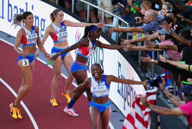 Melissa Jefferson, Abby Steiner, Jenna Prandini and Twanisha Terry celebrate winning the women's 4x100 metres relay final.