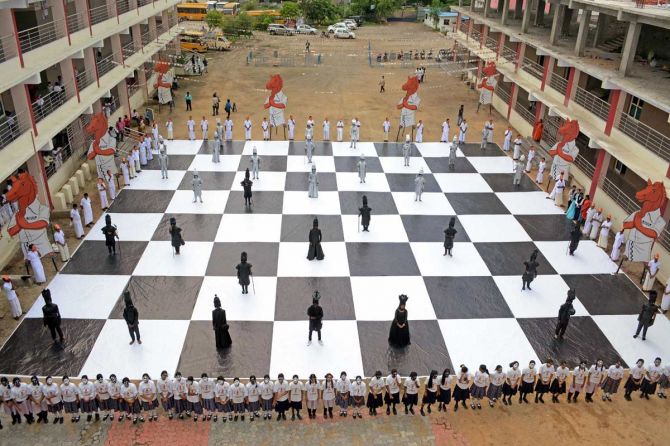 Children dressed as chess pieces perform at an event in Chennai on July 26, 2022, ahead of the Chess Olympiad 2022