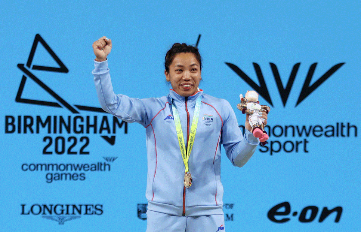 Gold medalist Saikhom Mirabai Chanu celebrates during the medal ceremony for Women's Weightlifting 49kg Final on day two of the Birmingham 2022 Commonwealth Games at NEC Arena in Birmingham on Saturday