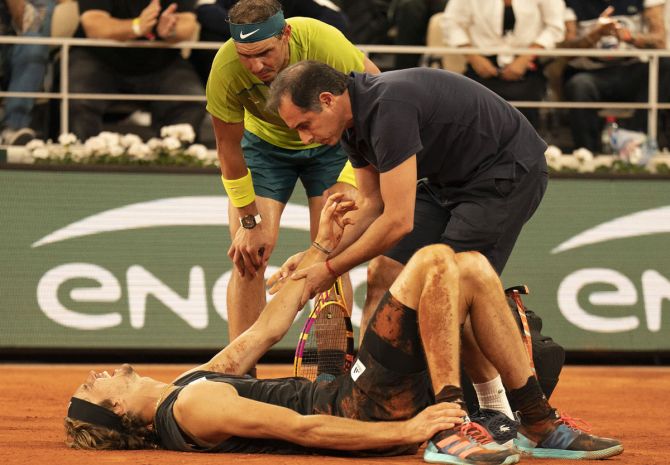 Rafael Nadal checks on the injured Alexander Zverev during their French Open semi-final on Saturday