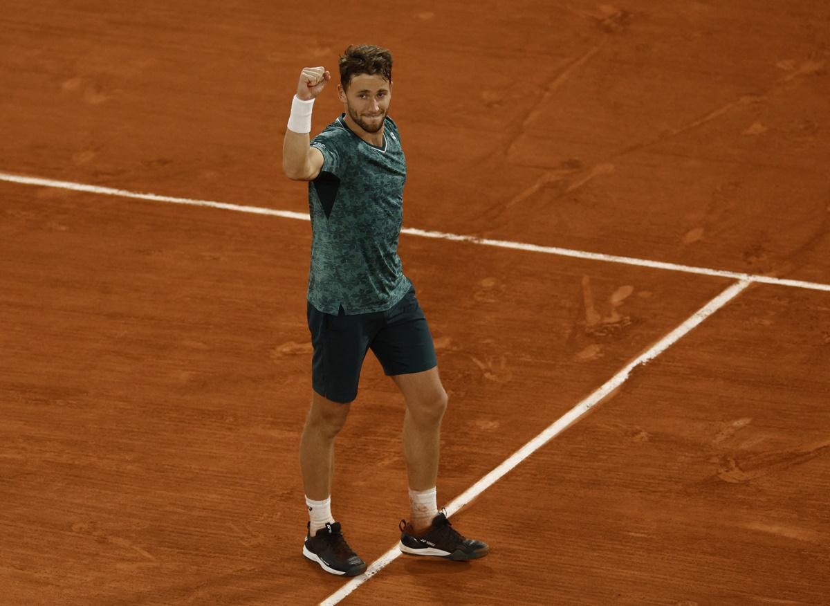 Casper Ruud raises his hand in triumph after becoming the first Norwegian man to reach a Grand Slam singles final.