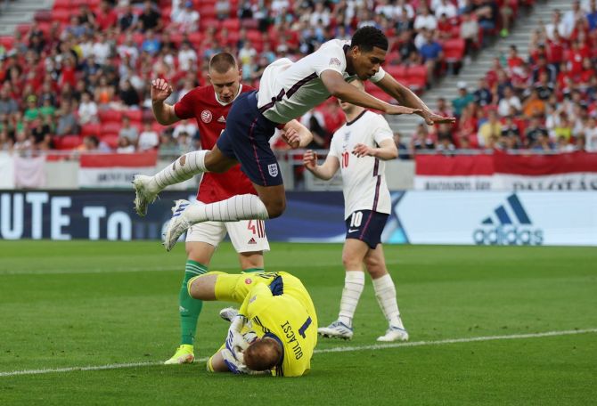 Hungary's goalkepeer Peter Gulacsi rushes out to thwart England's Jude Bellingham.