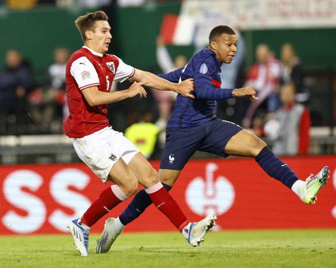 Kylian Mbappe sends the ball into the goal to earn France a draw against Austria in the UEFA Nations League Group A match at Ernst Happel Stadium, in Vienna, on Friday.