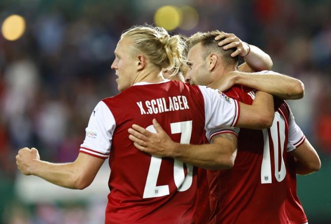 Andreas Weimann celebrates with Konrad Laimer and Xaver Schlager after putting Austria ahead.