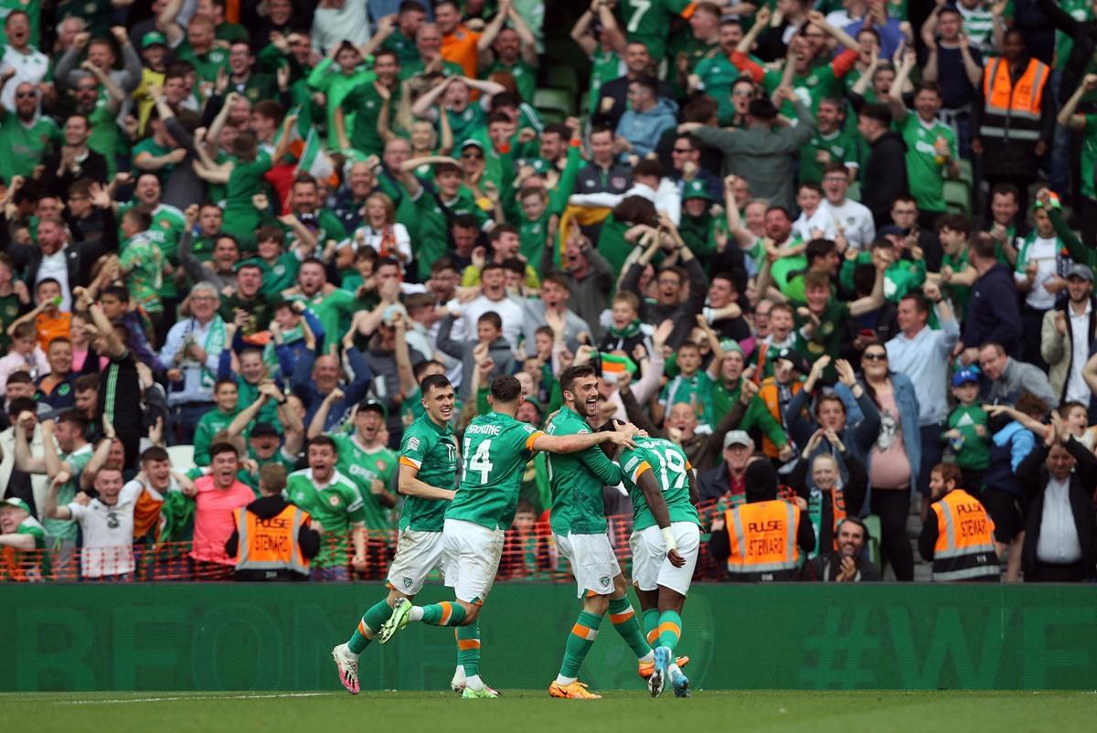 Michael Obafemi celebrates scoring Ireland's third goal with Troy Parrott, Alan Browne and Jason Knight.