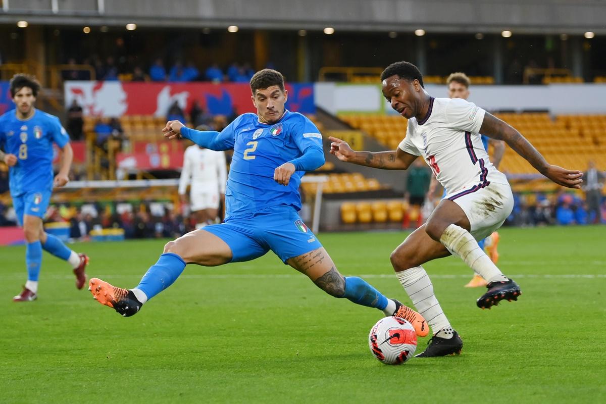 England's Raheem Sterling is challenged by Giovanni Di Lorenzo.