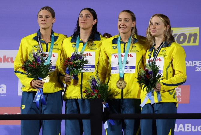 Women's 4x100m freestyle relay gold medallists, Australia's Mollie O'Callaghan, Madison Wilson, Meg Harris and Shayna Jack celebrate on the podium.