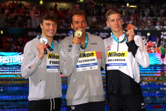(L-R) Silver medalist Bobby Finke of the United States, gold medalist Gregorio Paltrinieri of Italy and bronze medalist Florian Wellbrock of Germany pose with their medals from the men's 1500m freestyle.