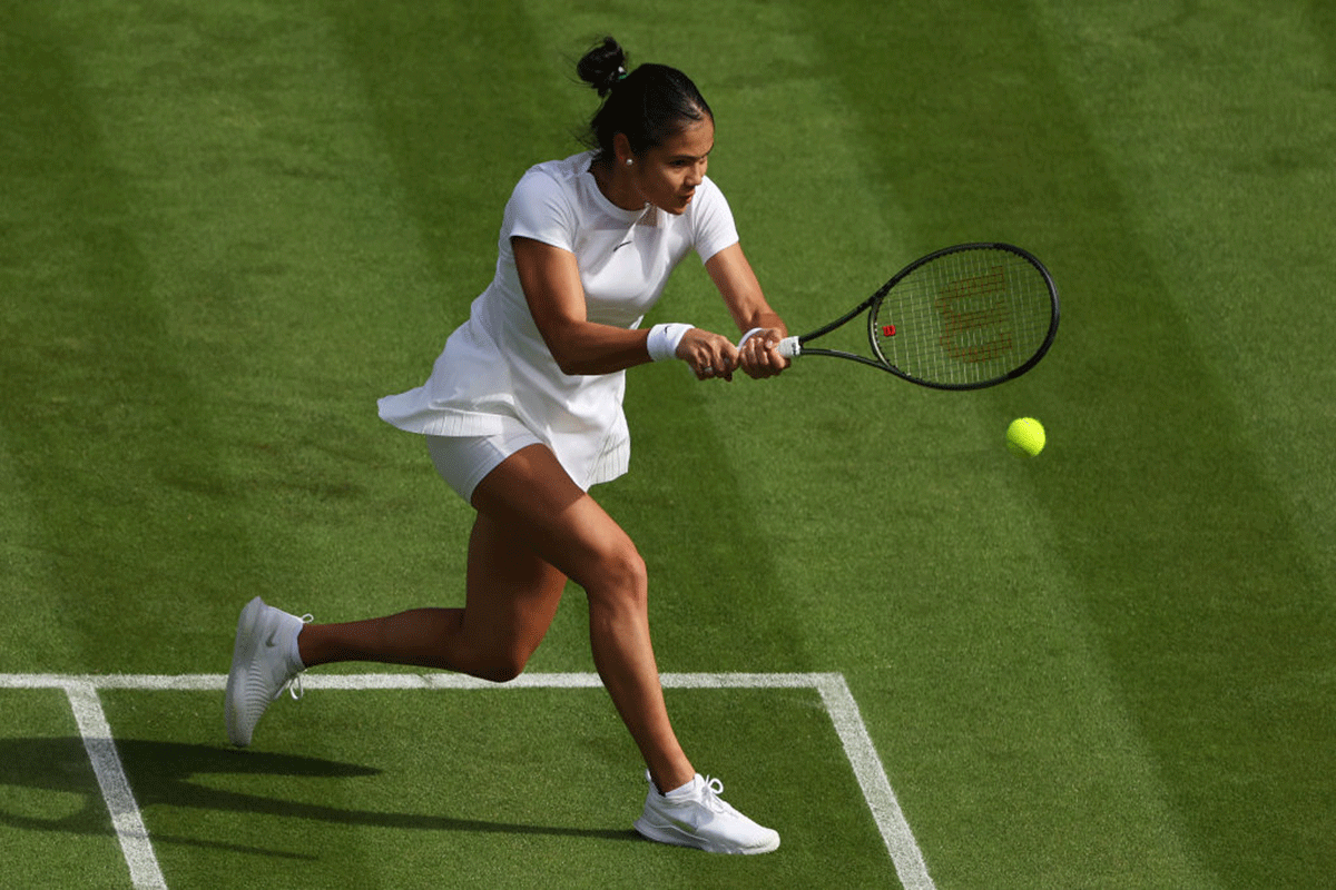 Great Britain's Emma Raducanu plays a backhand against Alison Van Uytvanck of Belgium in their first round match