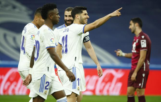 Marco Asensio celebrates scoring Real Madrid's fourth goal with teammates.