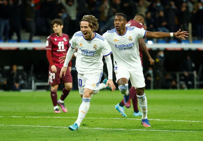 Luka Modric celebrates scoring Real Madrid's second goal with David Alaba during the La Liga match against Real Sociedad, at Santiago Bernabeu, in Madrid, on Saturday.