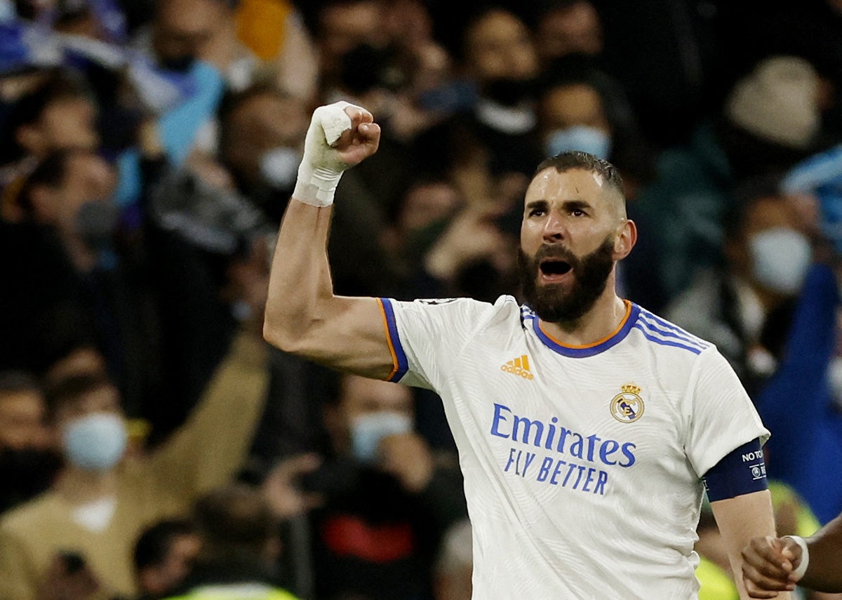 Karim Benzema celebrates scoring Real Madrid's third goal against Paris St Germain in the Champions League Round of 16 second Leg match. at the Santiago Bernabeu, in Madrid, Spain, on Wednesday.