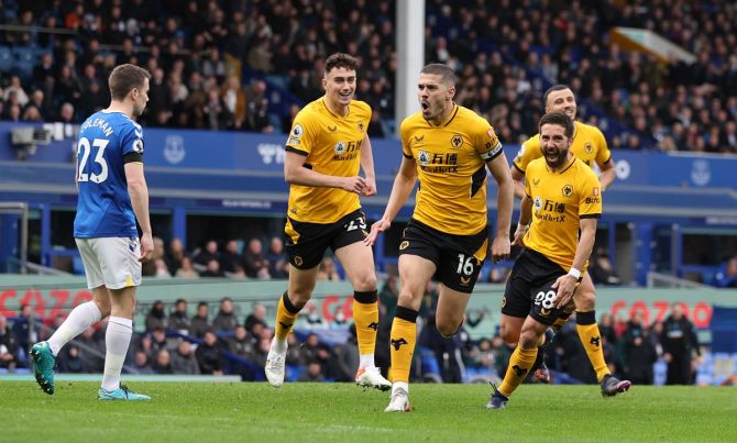 Conor Coady celebrates with Joao Moutinho, Max Kilman and Romain Saiss after scoring for Wolverhampton Wanderers against Everton, at Goodison Park, Liverpool. 