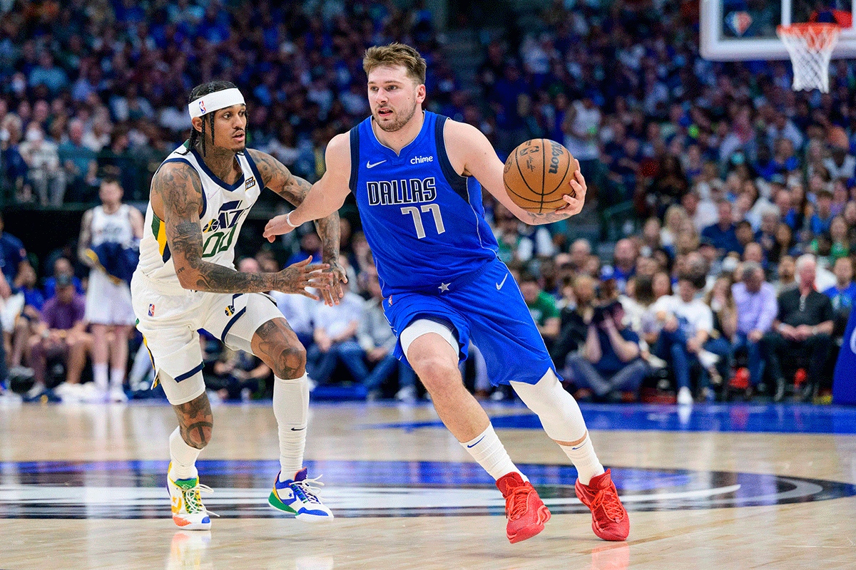 Dallas Mavericks guard Luka Doncic (77) brings the ball up court past Utah Jazz guard Jordan Clarkson (00) during the second half of their NBA game at the American Airlines Center in Dallas, Texas, on Sunday