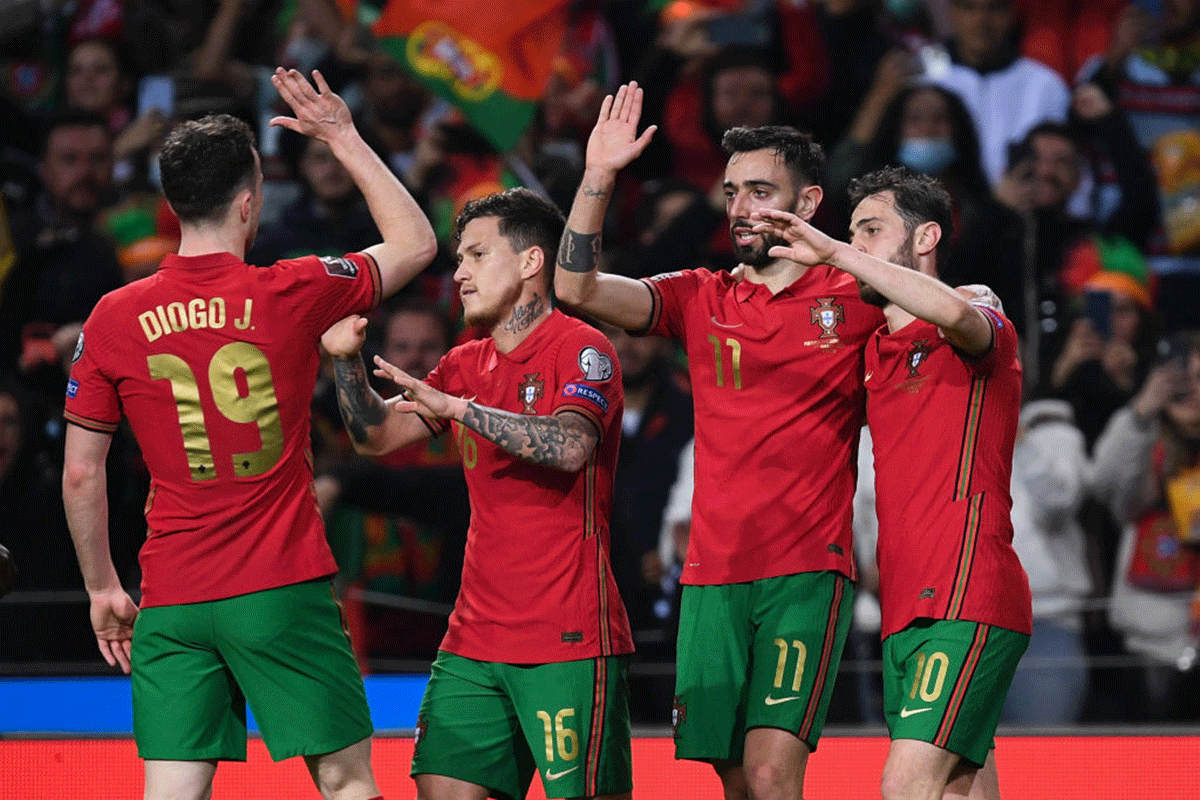 Portugal's Bruno Fernandes (2nd from right) celebrates with teammates after scores their second goal against North Macedonia during the 2022 FIFA World Cup Qualifier knockout round play-off match at Estadio do Dragao in Porto, Portugal. 