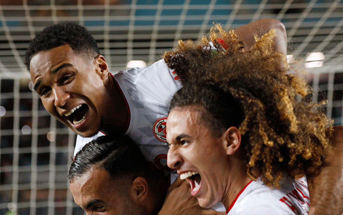 Tunisia's Seifeddine Jaziri and teammates celebrate after beating Mali in the African qualifiers to make the World Cup at Stade Olympique De Rades, Rades, Tunisia