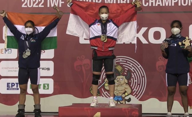 Indonesia’s gold medallist Windy Cantika Aisah and India’s Gyaneshwari Yadav (silver) and compatriot V Rithika (bronze) pose with their medals from the women's 49kg at the IWF Junior World Weightlifting Championships in Heraklion, Greece, on Monday.