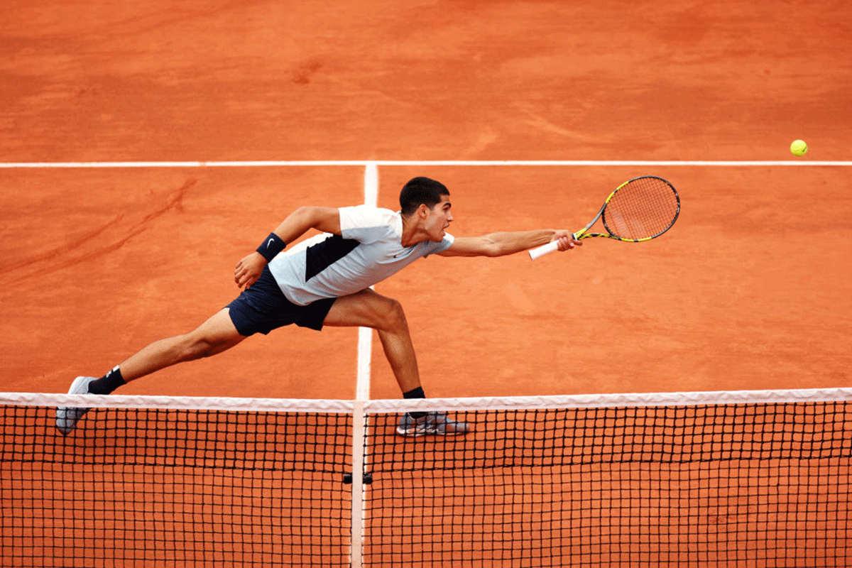 Spain's Carlos Alcaraz stretches to return against compatriot Albert Ramos-Vinolas during their second round match on Wednesday