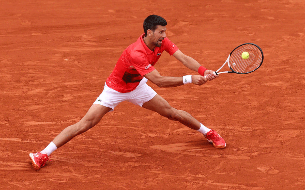 Novak Djokovic plays a backhand return against Diego Schwartzman