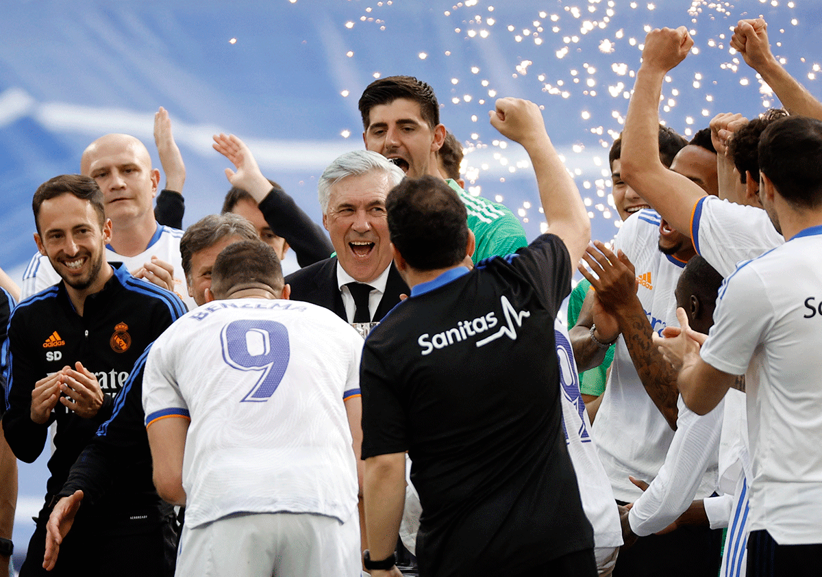 Real Madrid coach Carlo Ancelotti celebrates with team members after winning La Liga