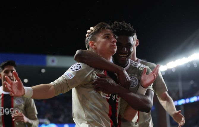 Francisco Conceicao celebrates scoring Ajax Amsterdam's third goal with Mohammed Kudus during the Champions League Group A match agaiknst Rangers, at Ibrox Stadium, Glasgow, Scotland.