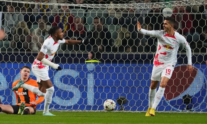 Christopher Nkunku, left, celebrates scoring RB Leipzig's first goal with Andre Silva during the  Champions League last 16 Group F match against Shakhtar Donetsk, at Stadion Wojska Polskiego, Warsaw, Poland.