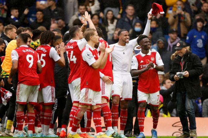 Arsenal's Bukayo Saka and Gabriel celebrate after the match