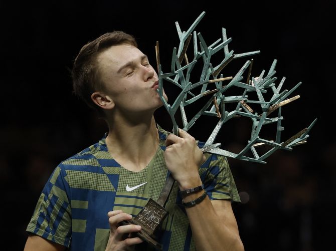 Denmark's Holger Rune celebrates with the trophy after defeating Serbia's Novak Djokovic to win the ATP Masters 1000 Paris Masters crown, at Accor Arena, Paris, France, on Sunday.