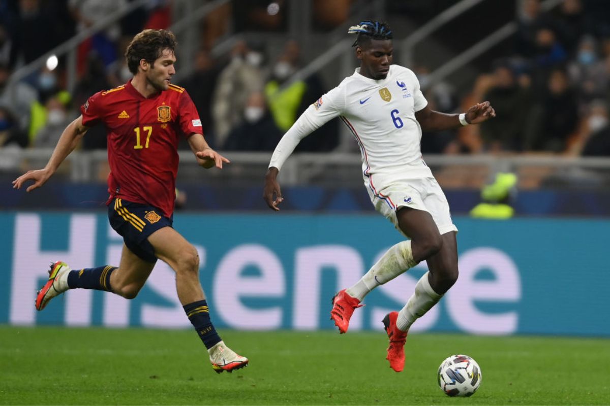 Paul Pogba of France is challenged by Marcos Alonso of Spain 