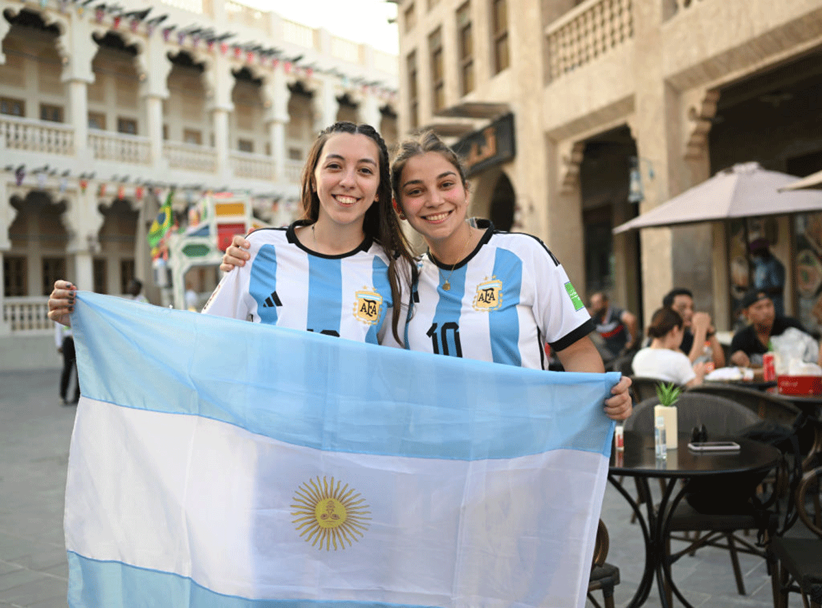 Argentina supporters hold the Argentine flag at the Souq Wagif in Doha ahead of the FIFA World Cup Qatar 2022