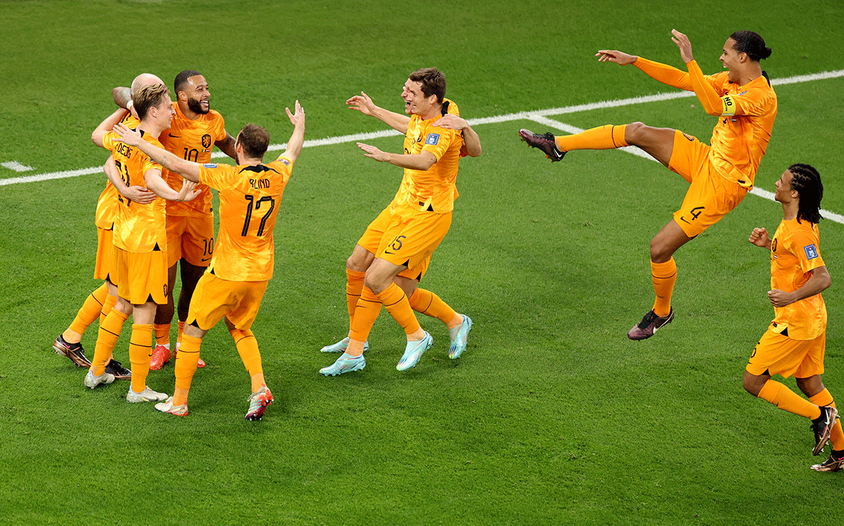 Netherlands' Davy Klaassen is rounded by teammates as they celebrate scoring their second goal against Senegal during their FIFA World Cup Group A match at Al Thumama Stadium, Doha, Qatar, on Monday 