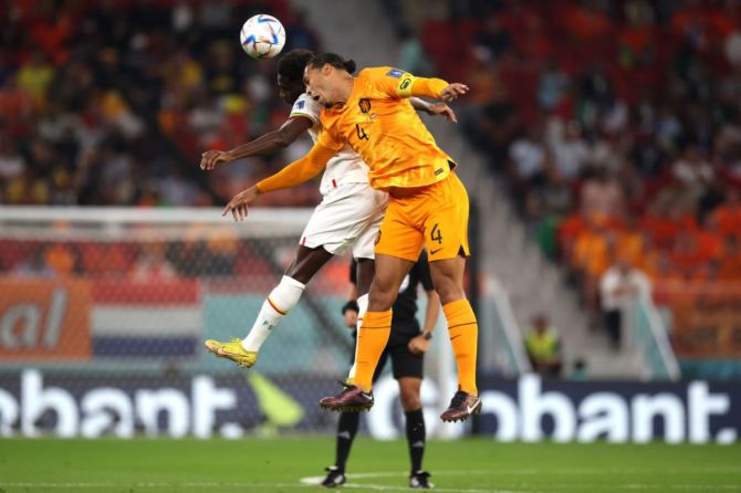 Boulaye Dia of Senegal jumps for the ball with Virgil Van Dijk of Netherlands