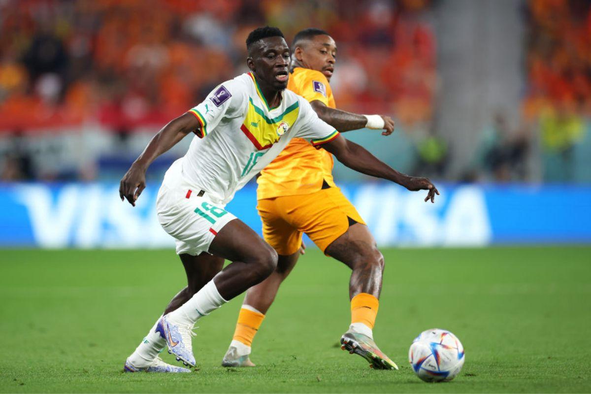 Ismaila Sarr of Senegal battles for possession with Steven Bergwijn of Netherlands during the FIFA World Cup Qatar 2022 