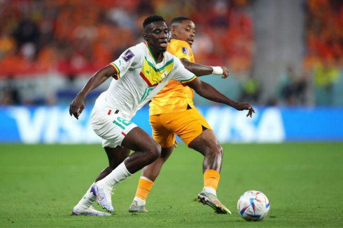Ismaila Sarr of Senegal battles for possession with Steven Bergwijn of Netherlands during the FIFA World Cup Qatar 2022 
