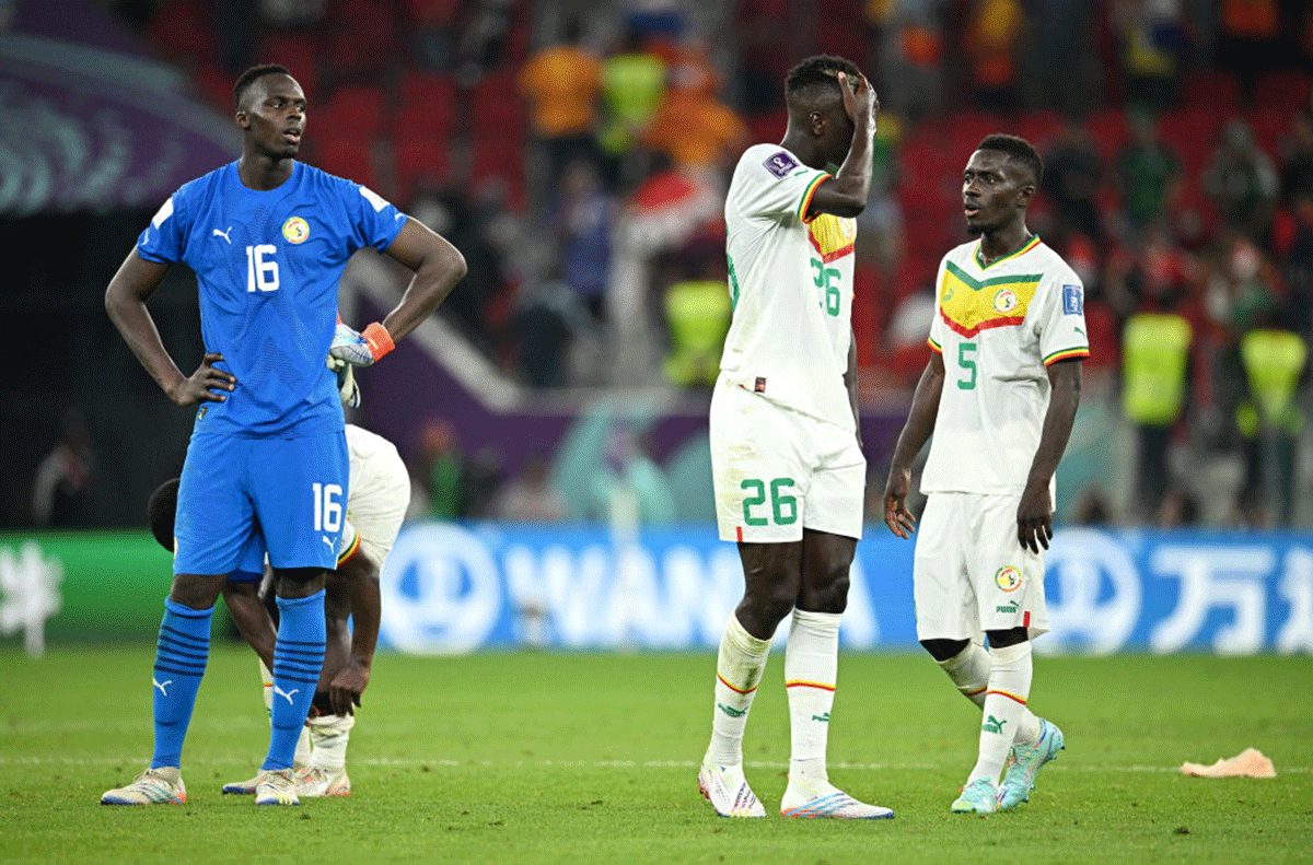 Senegal players (L-R) Edouard Mendy, Pape Gueye and Idrissa Gana Gueye react after their loss