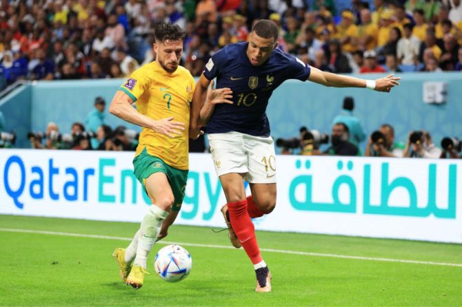 Kylian Mbappe of France battles for possession with Mathew Leckie of Australia during the FIFA World Cup Qatar 2022 Group D match