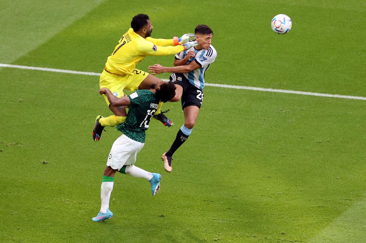 Saudi Arabia's Mohammed Al-Owais collides with teammate Yasser Al-Shahrani