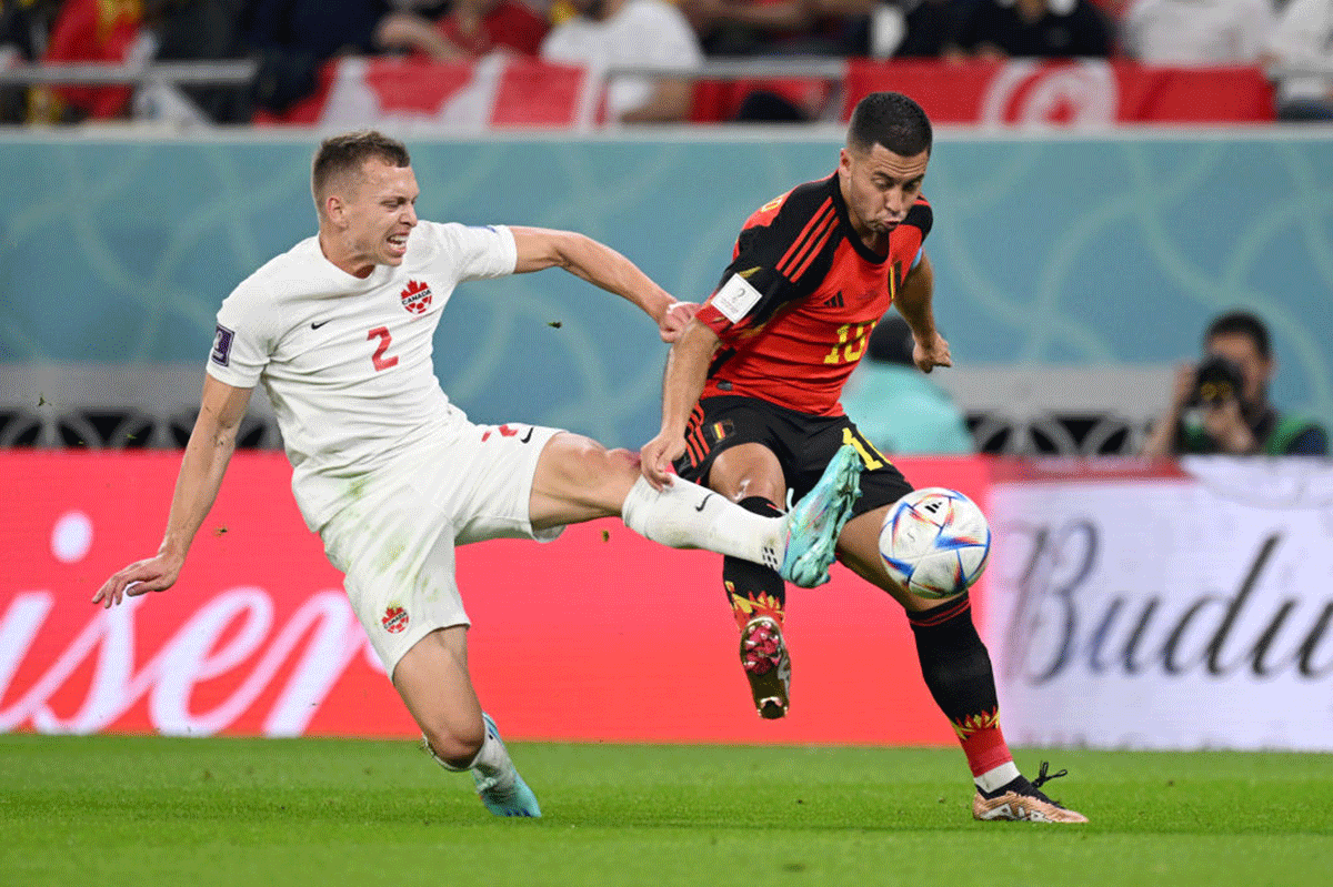 Belgium's Eden Hazard battles for possession with Canada's Alistair Johnston