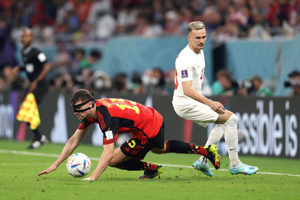 Belgium's Thomas Meunier and Canada's Liam Millar battle for the ball