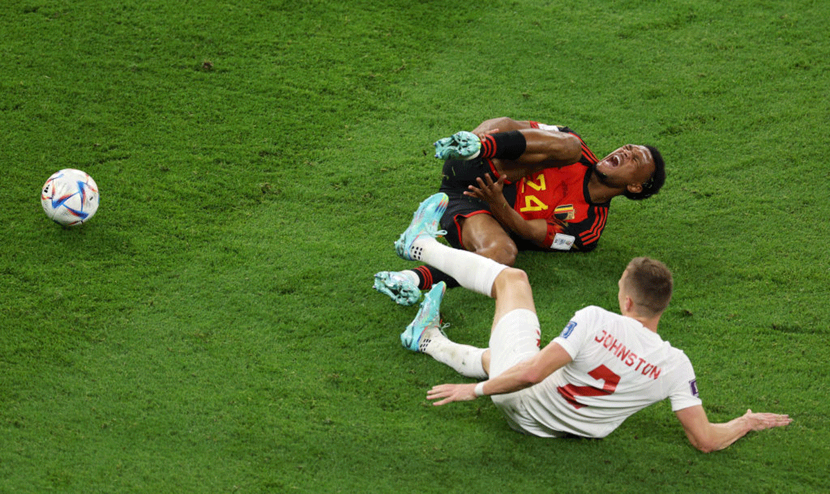 Belgium's Lois Openda reacts after being tackled by Canada'sAlistair Johnston