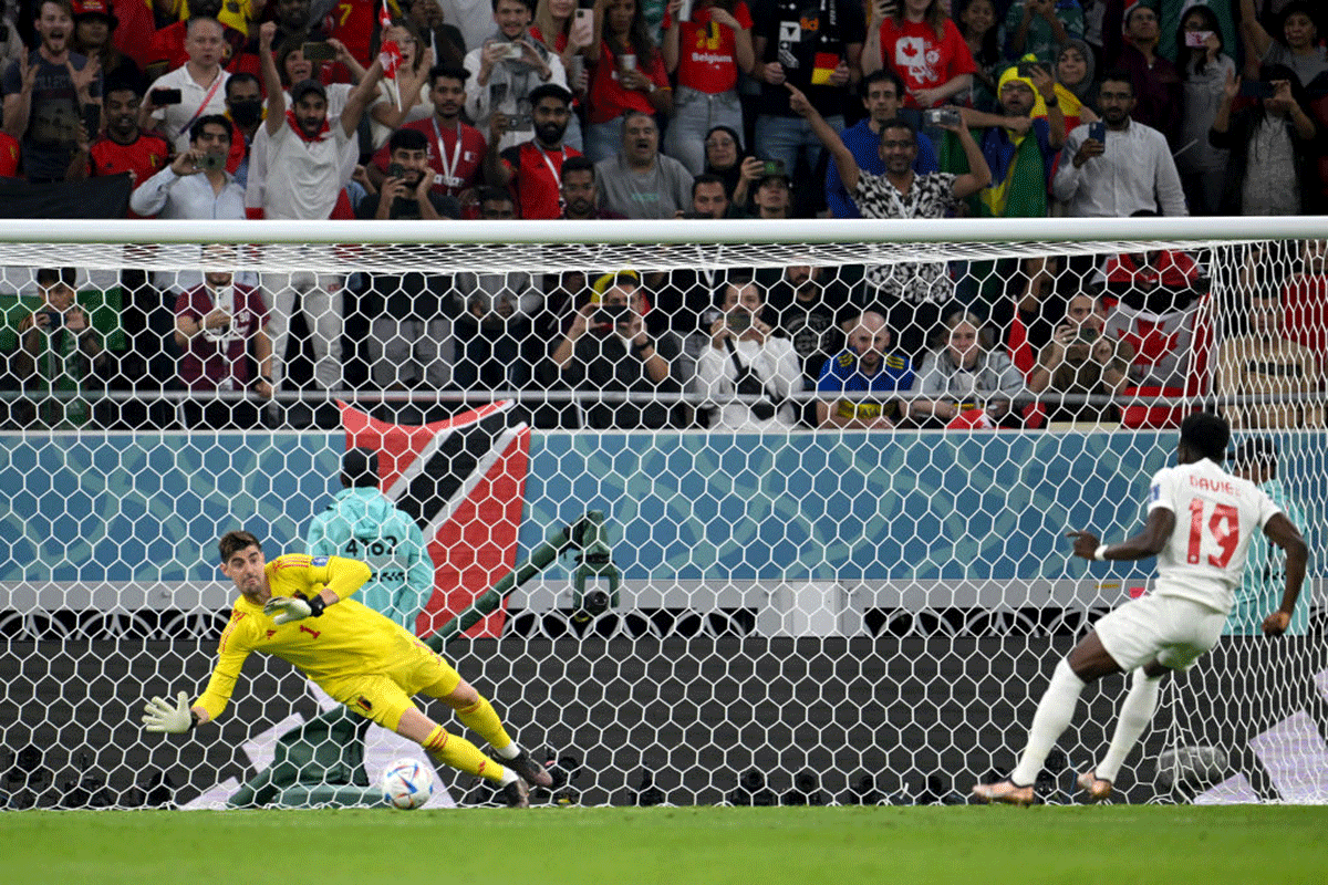 Belgium's Thibaut Courtois saves the penalty taken by Canada's Alphonso Davies 