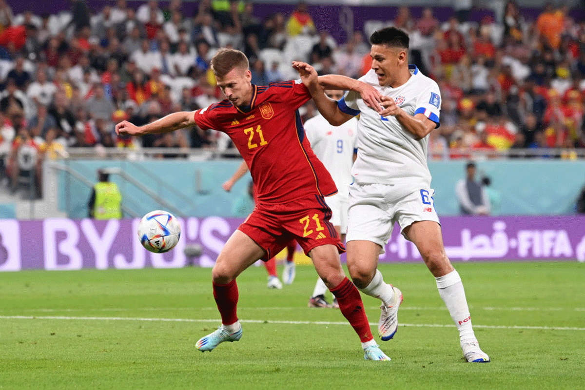 Spain's Dani Olmo wins the ball in a challenge against Costa Rica's Oscar Duarte