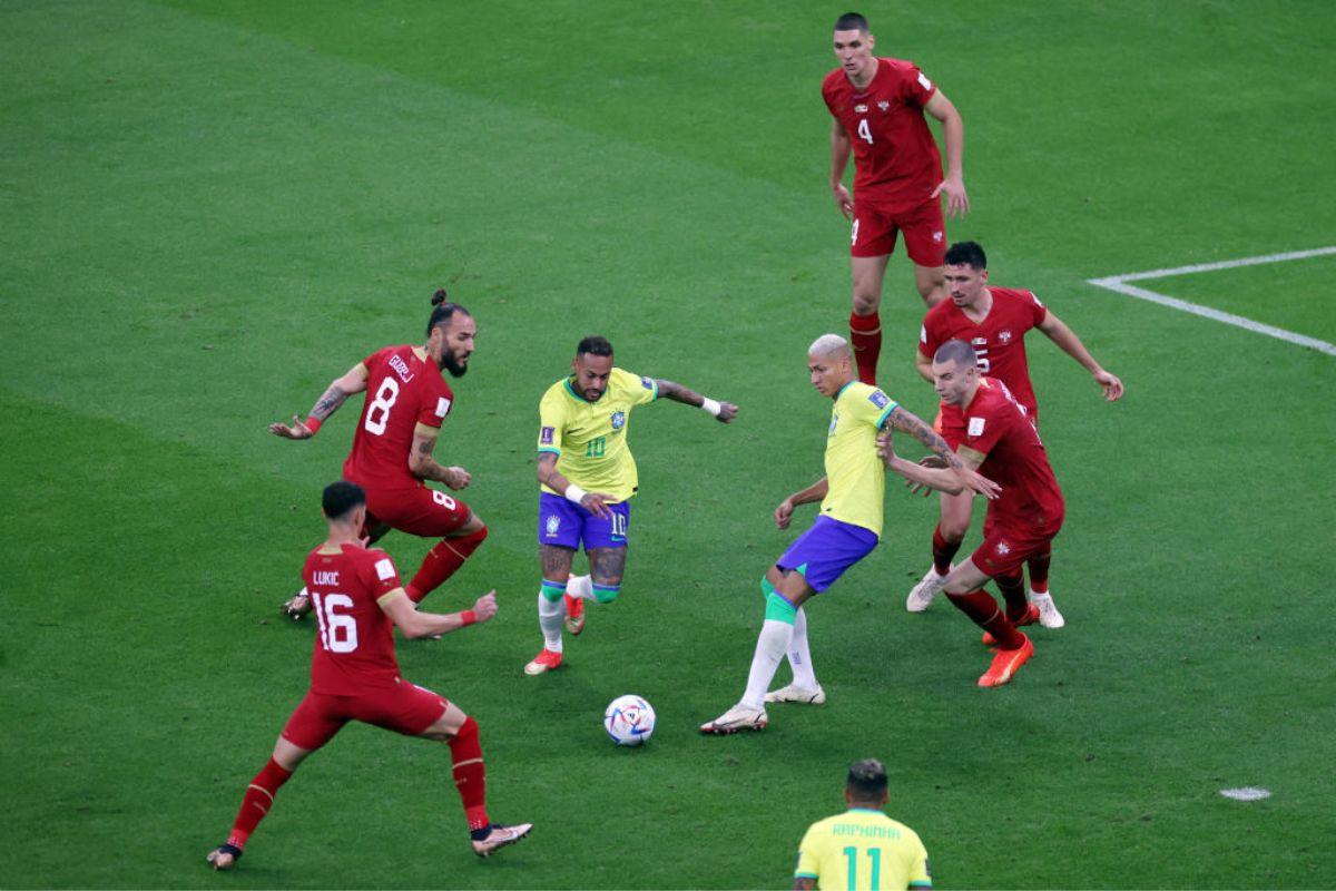 Neymar of Brazil battles for possession with Nemanja Gudelj and Sasa Lukic of Serbia during the FIFA World Cup Qatar 2022 Group G match